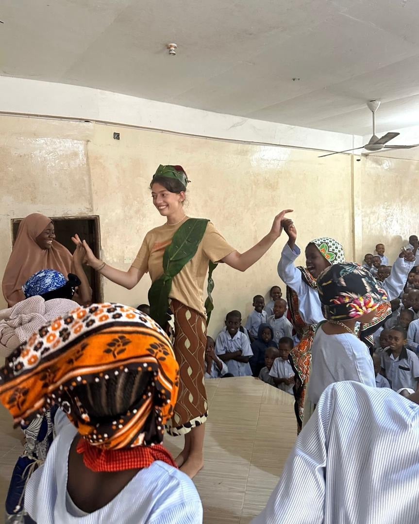 Volunteer dancing with local community